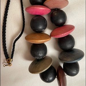 Beaded necklace in pink blue brown green & mauve colours on braided string